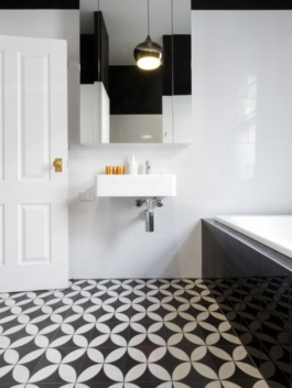 Luxury monochrome designer bathroom renovation with patterned floor tiles