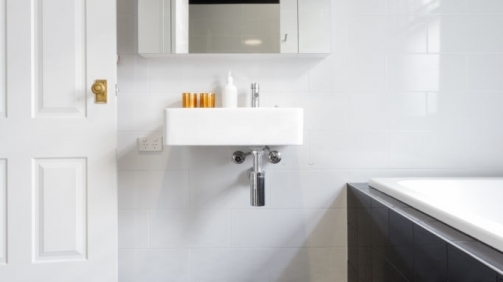 Luxury monochrome designer bathroom renovation with patterned floor tiles