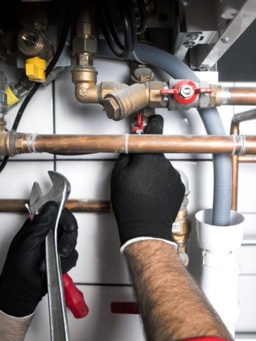 plumber working at home, work at the heating installation